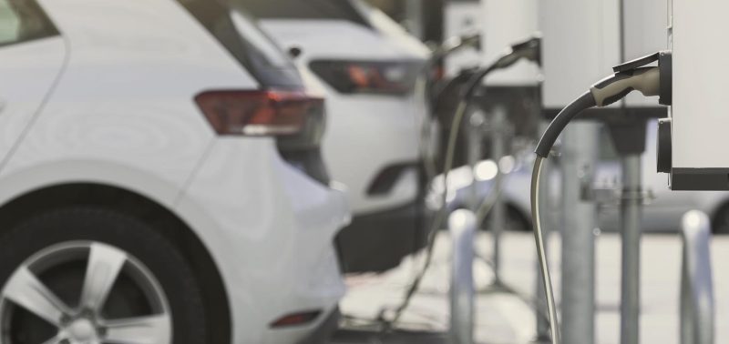 A parking lot with charging stations for electric cars.